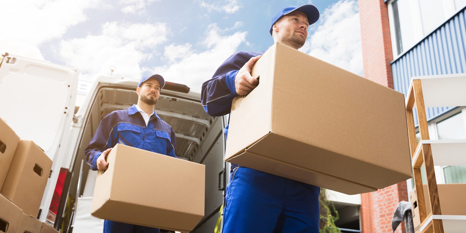 Delivery Men Carrying Cardboard Boxes