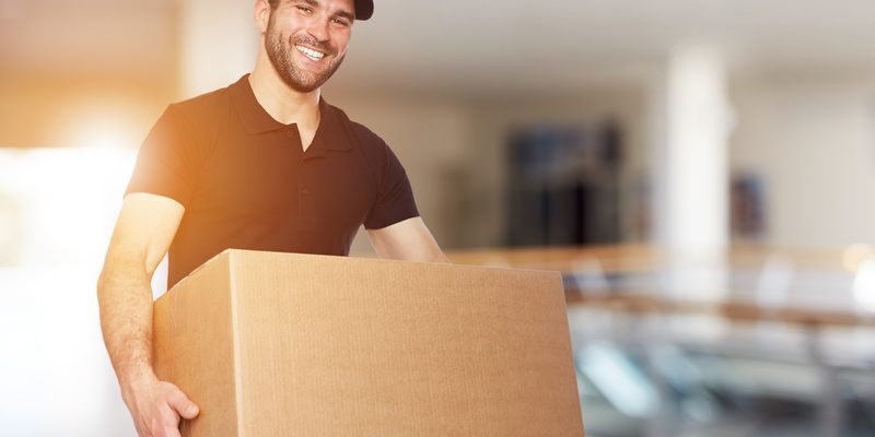 Happy delivery man with box